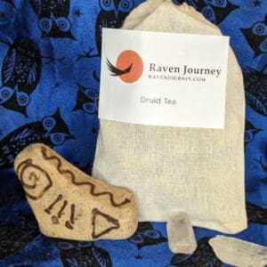 A bag of tea and some rocks on a blue cloth