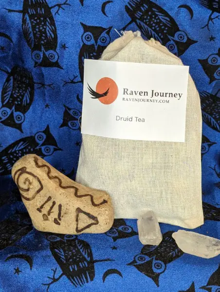 A bag of tea and some rocks on a blue cloth