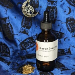 A bottle of raven journey oil sitting on top of a blue blanket.