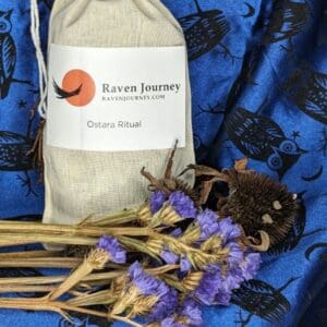 A bag of tea and some flowers on a blue cloth