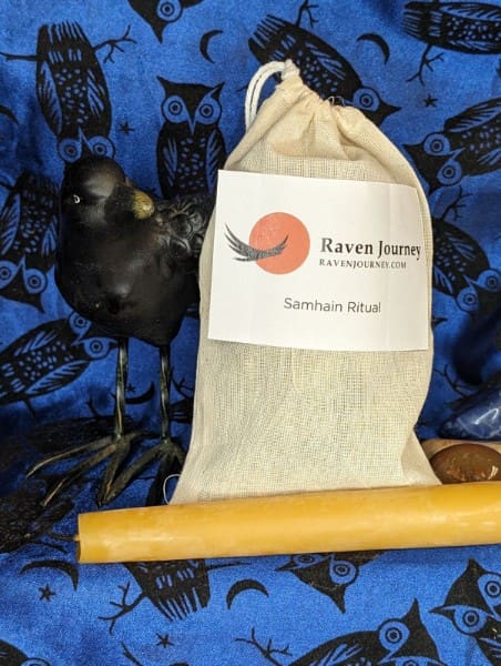 A bag of black raven feathers sitting on top of a blue blanket.