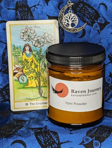 A jar of honey next to a tarot card.